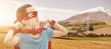 Composite image of cute girl in eye mask and cape