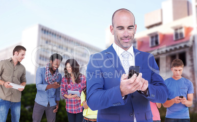 Composite image of smiling businessman using mobile phone