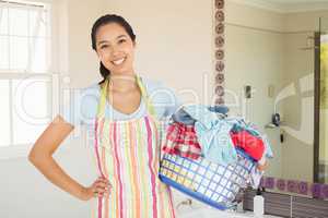 Composite image of happy woman with laundry basket