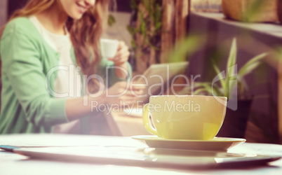 Composite image of cup of coffee and tablet pc