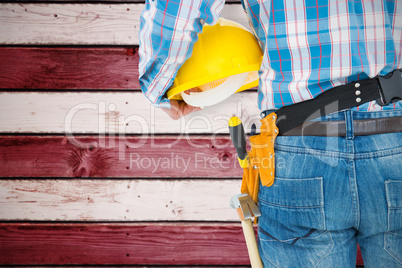 Composite image of rear view of handyman wearing tool belt