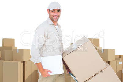 Composite image of delivery man pushing trolley of boxes on white background