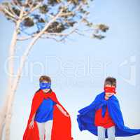 Composite image of masked kids running pretending to be superheroes
