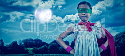 Composite image of girl in cape and eye mask
