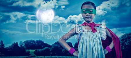Composite image of girl in cape and eye mask