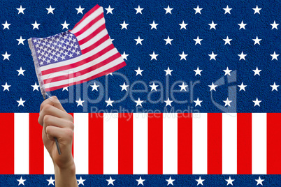 Digital composite of hand holding flag