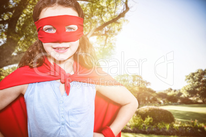 Composite image of little girl pretending to be a superhero