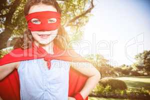 Composite image of little girl pretending to be a superhero