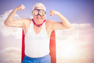 Composite image of senior man pretending to be a superhero