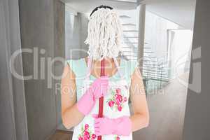 Composite image of woman hiding her face with a mop
