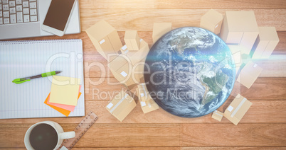Composite image of globe and cardboard boxes