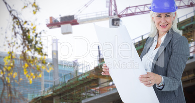 Composite image of selfassured businesswoman wearing a helmet