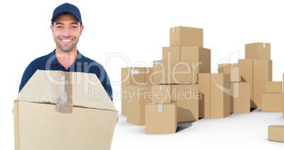 Composite image of happy delivery man holding cardboard box