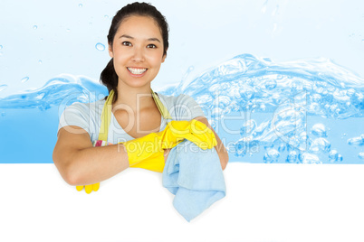 Composite image of smiling woman leaning on white surface