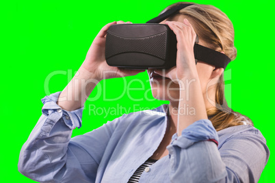 Composite image of woman using an oculus