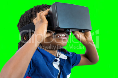 Composite image of boy wearing virtual reality simulator