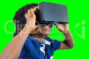 Composite image of boy wearing virtual reality simulator