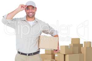 Composite image of portrait of happy delivery man with cardboard box wearing cap