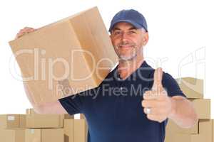 Composite image of happy delivery man holding cardboard box showing thumbs up