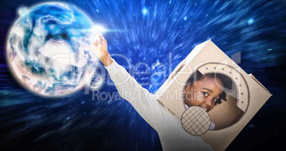 Composite image of boy playing as an astronaut in a park