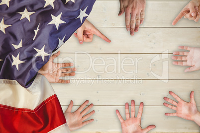 Human hand gesturing against fence