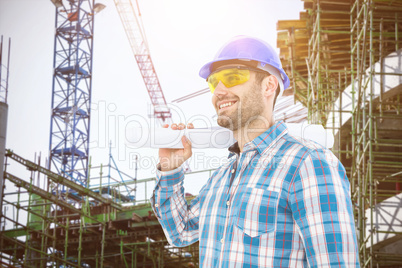 Composite image of smiling architect looking away while holding blueprint