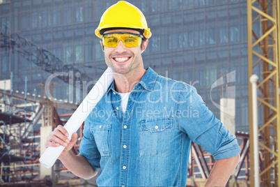 Composite image of architect holding rolled blueprint