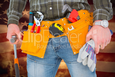 Composite image of manual worker holding gloves and hammer