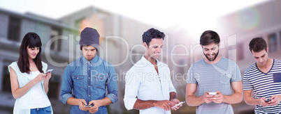 Composite image of handsome man text messaging through smart phone