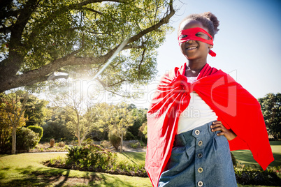 Composite image of happy girl in red cape