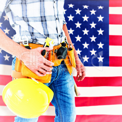 Composite image of technician with tool belt around waist and hard hat