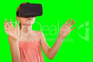 Composite image of little girl holding virtual glasses