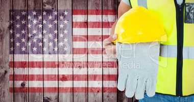 Composite image of construction worker holding gloves and hardhat