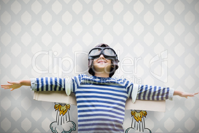 Composite image of boy pretending to be an aviation pilot