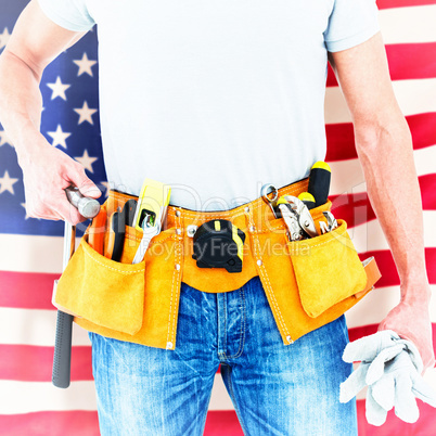 Composite image of technician holding gloves and hammer