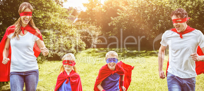 Composite image of happy family pretending to be superhero running