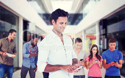 Composite image of handsome man using smart phone