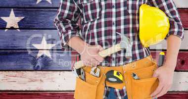 Composite image of repairman with hard hat and hammer