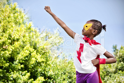 Composite image of little girl pretending to be a superhero