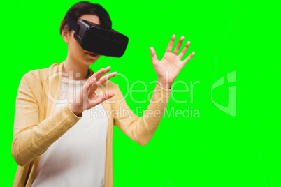 Composite image of businesswoman holding virtual glasses