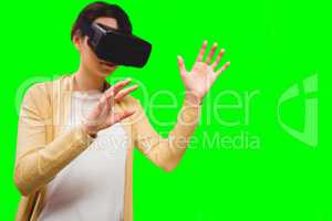 Composite image of businesswoman holding virtual glasses