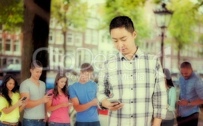 Composite image of young man using smart phone