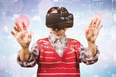 Composite image of young boy in red jumper with virtual reality headset