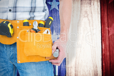 Composite image of technician with tool belt around waist