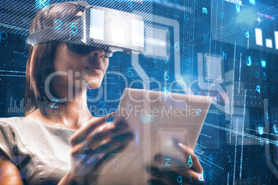 Composite image of businesswoman holding virtual glasses and tablet computer