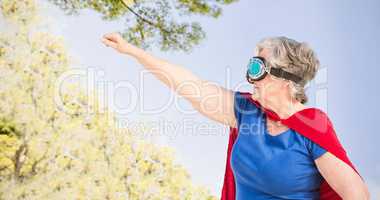 Composite image of senior woman wearing superwoman costume