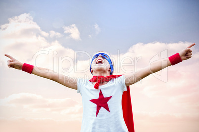 Composite image of little boy dressed as superman