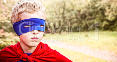Composite image of little boy pretending to be superhero