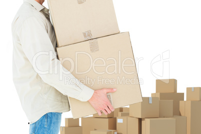 Composite image of delivery man carrying cardboard boxes