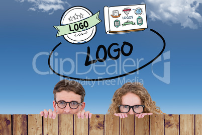 Composite image of geeky hipster couple holding poster